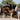 A rider in black equestrian attire and a black helmet sits on a brown horse jumping over a white jump obstacle in an outdoor equestrian arena.