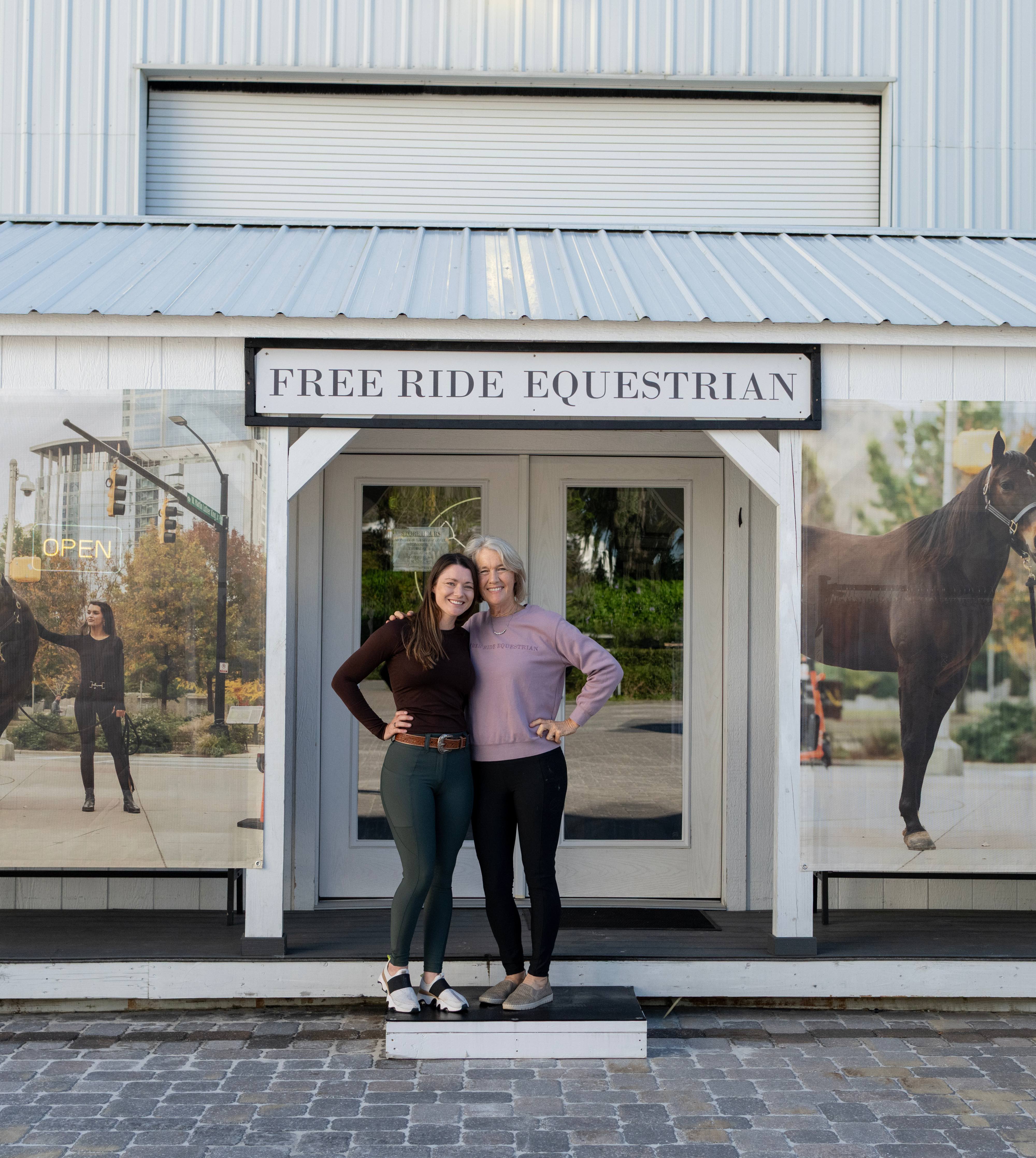 Katie and her mom standing in front of the Free Ride Equestrian Booth at the World Equestrian Center