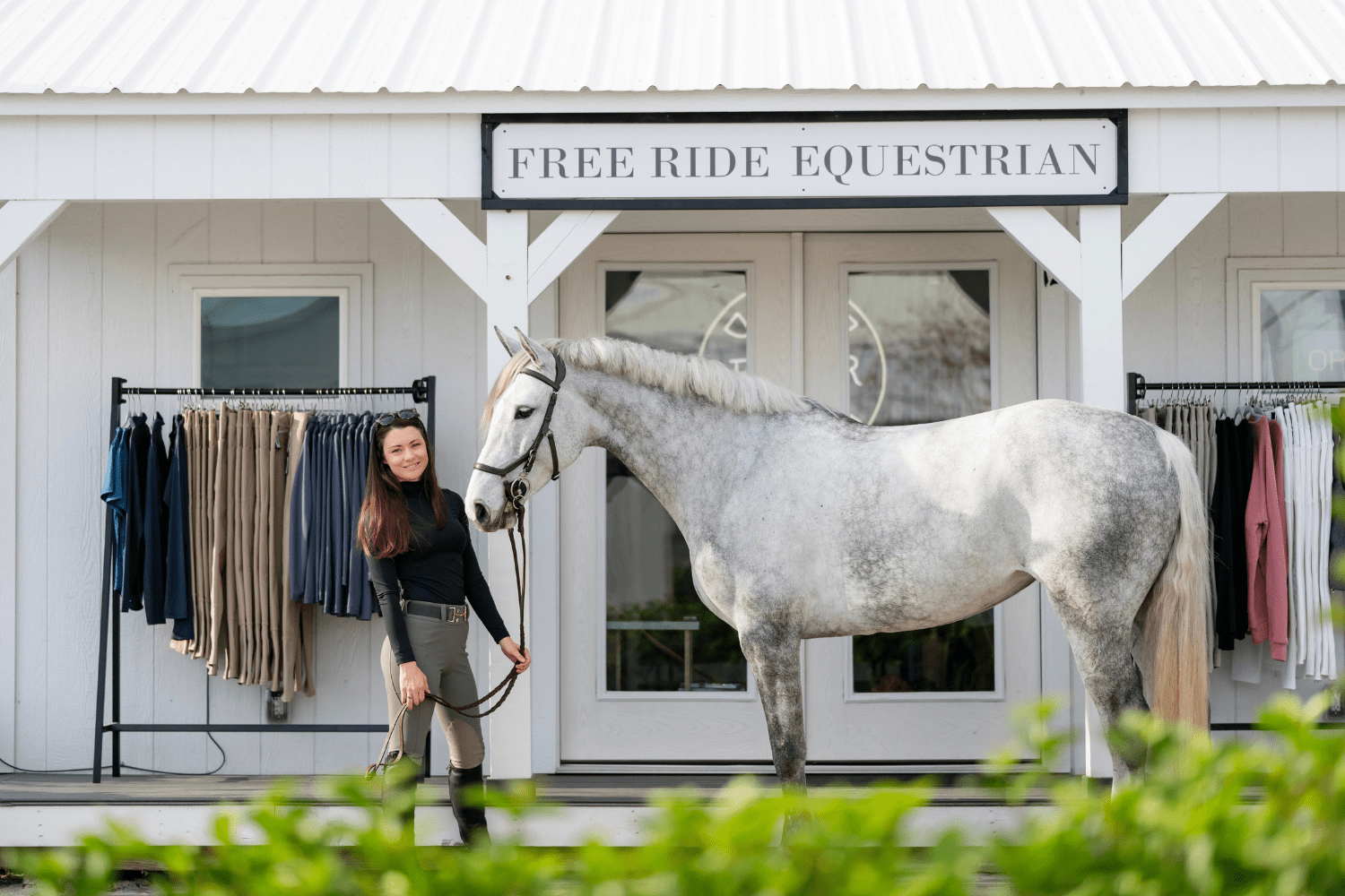 Katie and her horse standing in front of the Free Ride booth