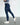 Person wearing navy  lux zip breeches on a white background